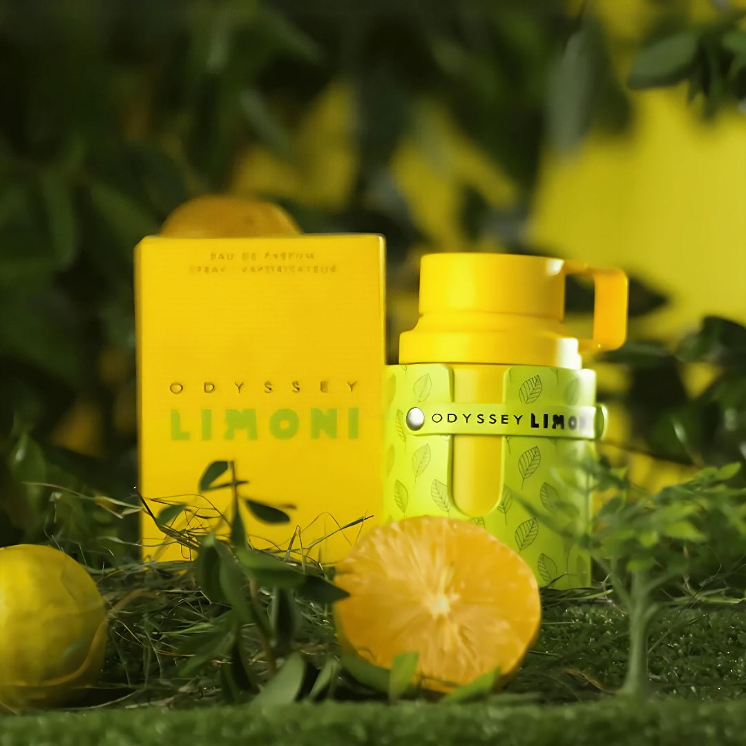 Odyssey Limoni perfume bottle and packaging on a grassy background with lemons.