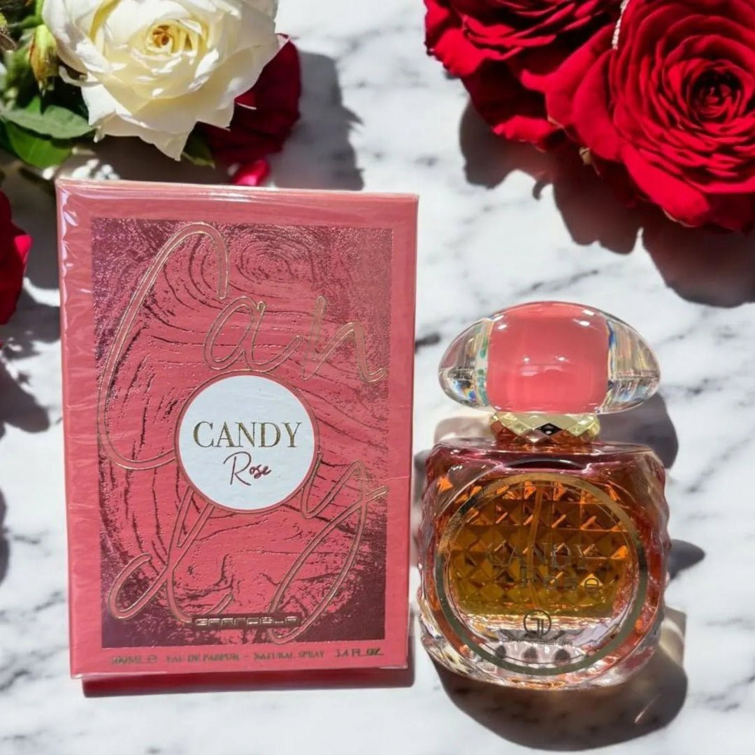 Perfume bottle and packaging of 'Candy Rose' with red roses on a marble surface