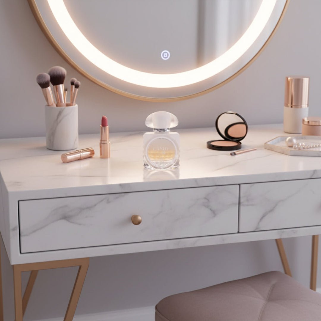 Marble-top vanity with makeup items and a round illuminated mirror.