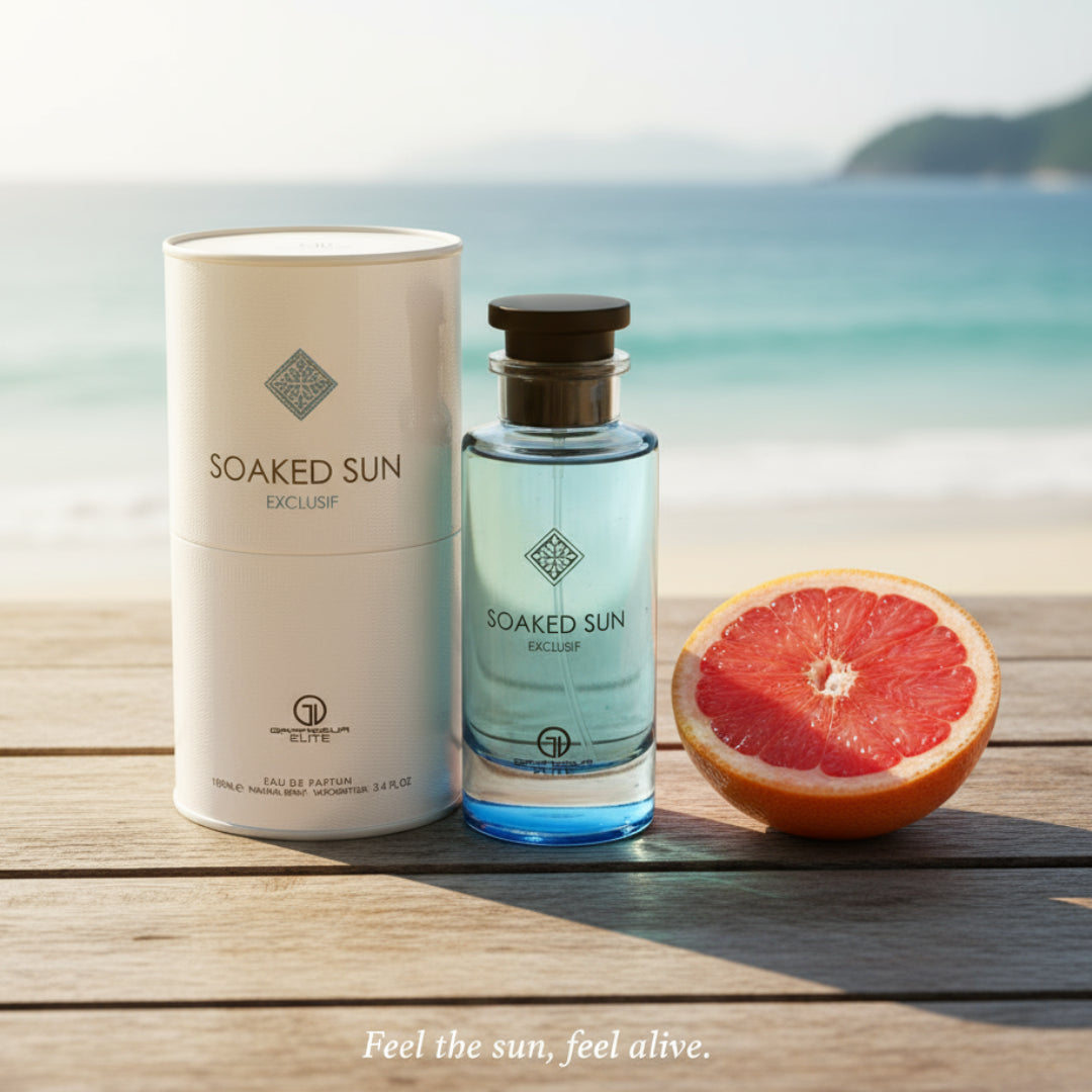 Men’s perfume bottle and box on beach wood table in Malaysia with grapefruit slice and ocean view &ndash; summer fresh fragrance