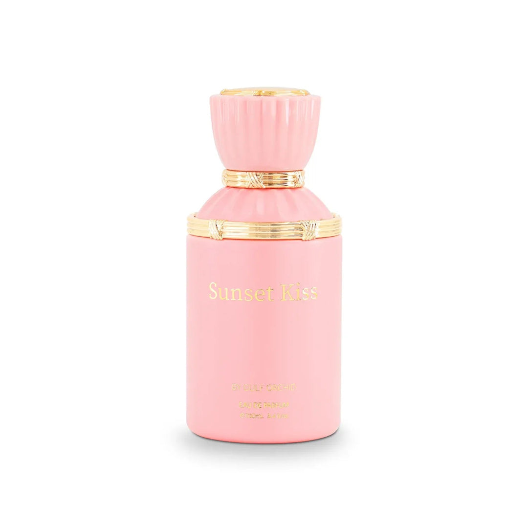 Pink perfume bottle with gold accents on a white background