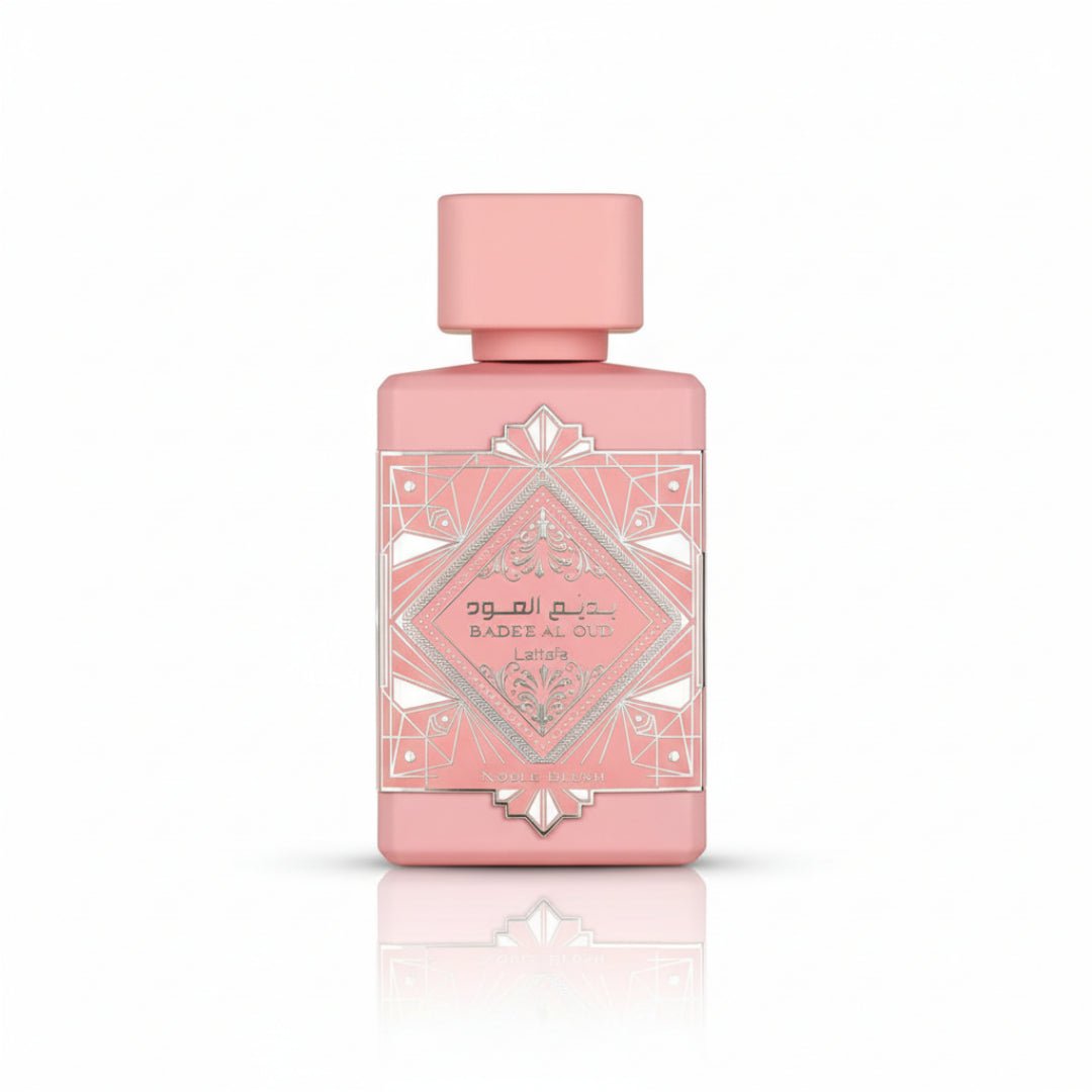 Pink perfume bottle with geometric design on a white background