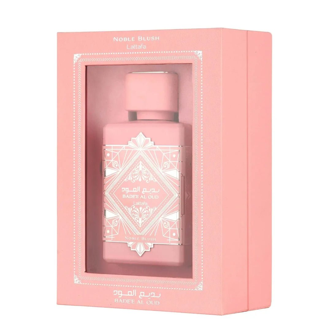 Pink perfume bottle in a matching pink box with 'Noble Blush' text on a white background