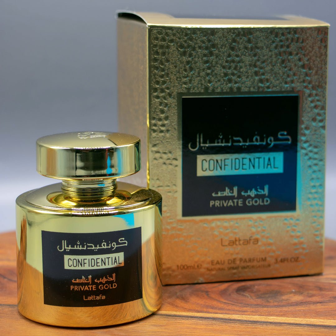 Gold perfume bottle and packaging with 'Confidential' label on a wooden surface.