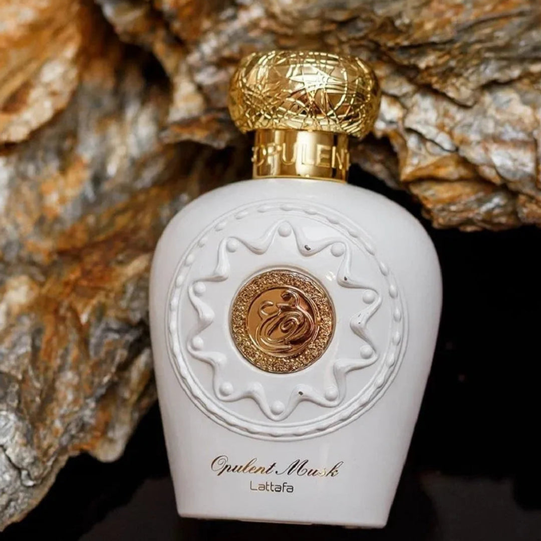 Opulent perfume bottle with gold accents on a textured stone background