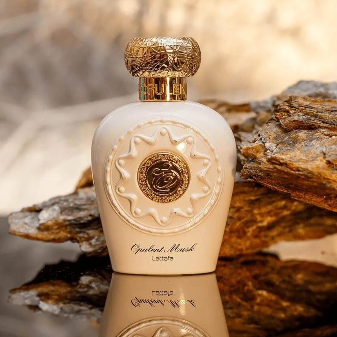 Perfume bottle with gold cap on a stone surface