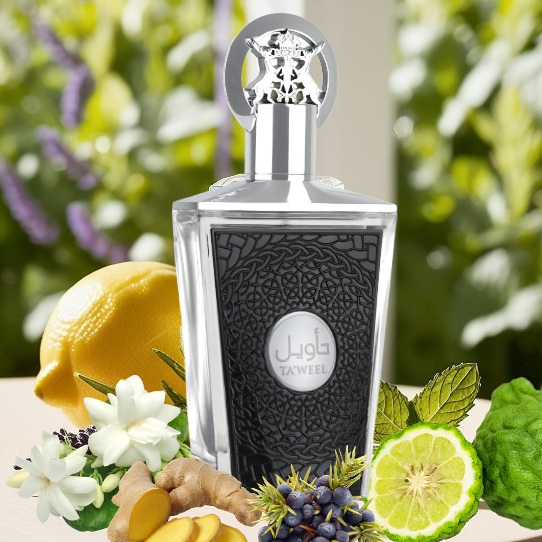 taweel lattafa Perfume bottle with decorative elements like lemons, flowers, and herbs on a blurred natural background
