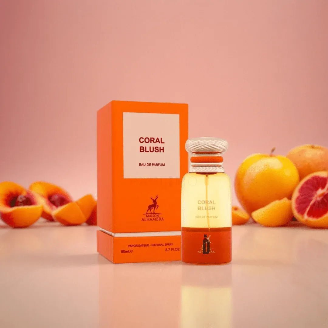 Coral Blush perfume bottle and packaging with fruits on a pink background