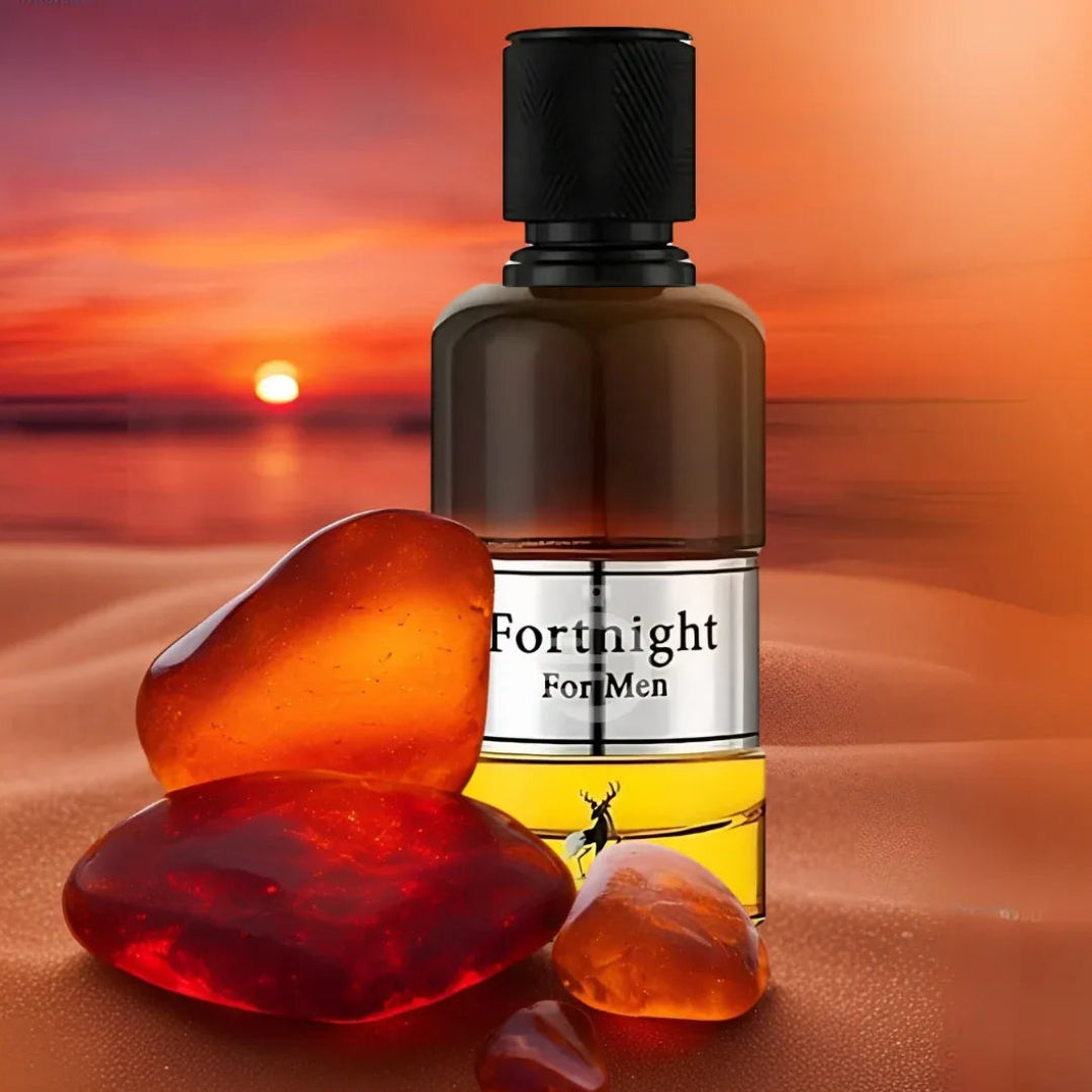 Perfume bottle labeled 'Fortnight For Men' with amber stones against a sunset beach background