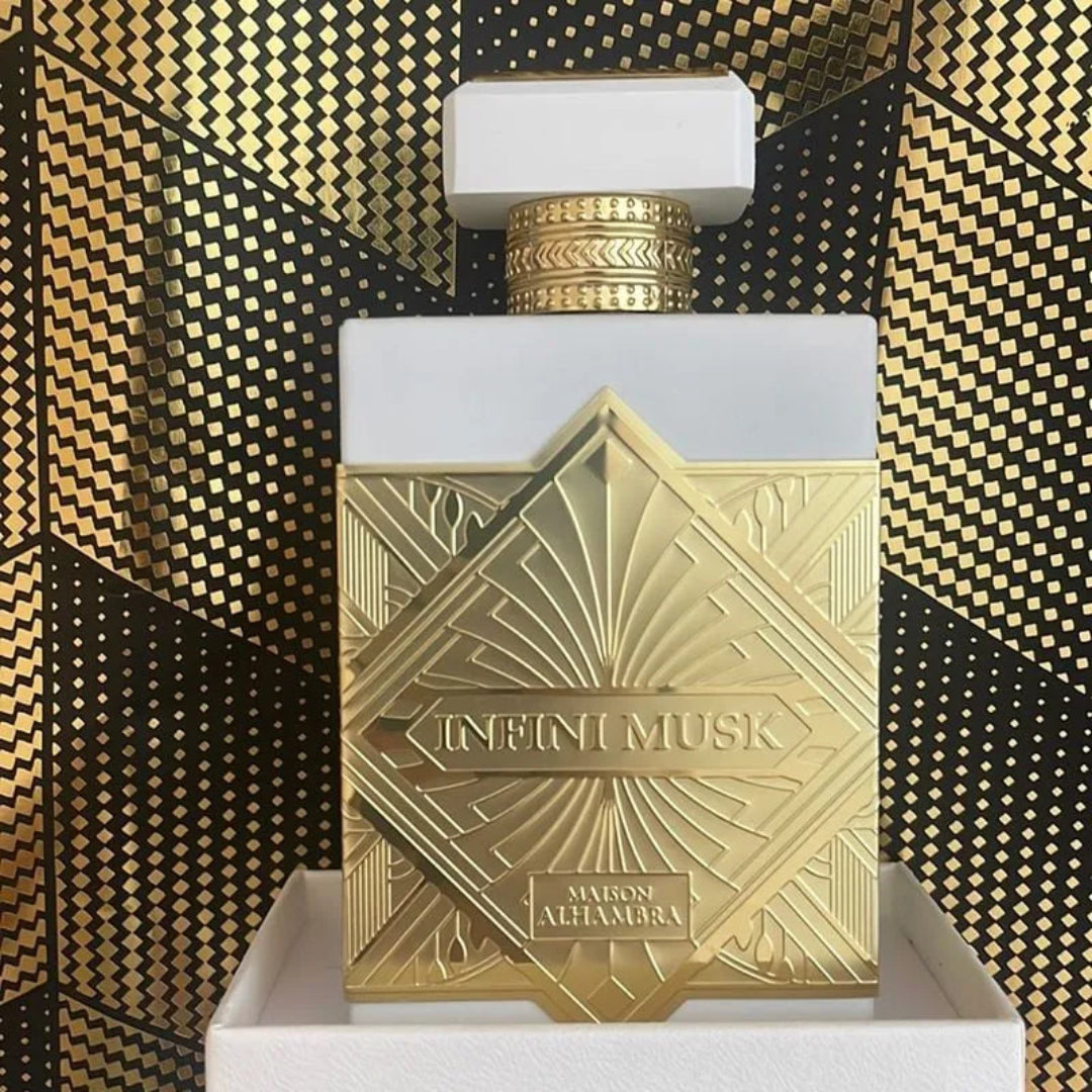 Perfume bottle with gold and white design on a patterned background