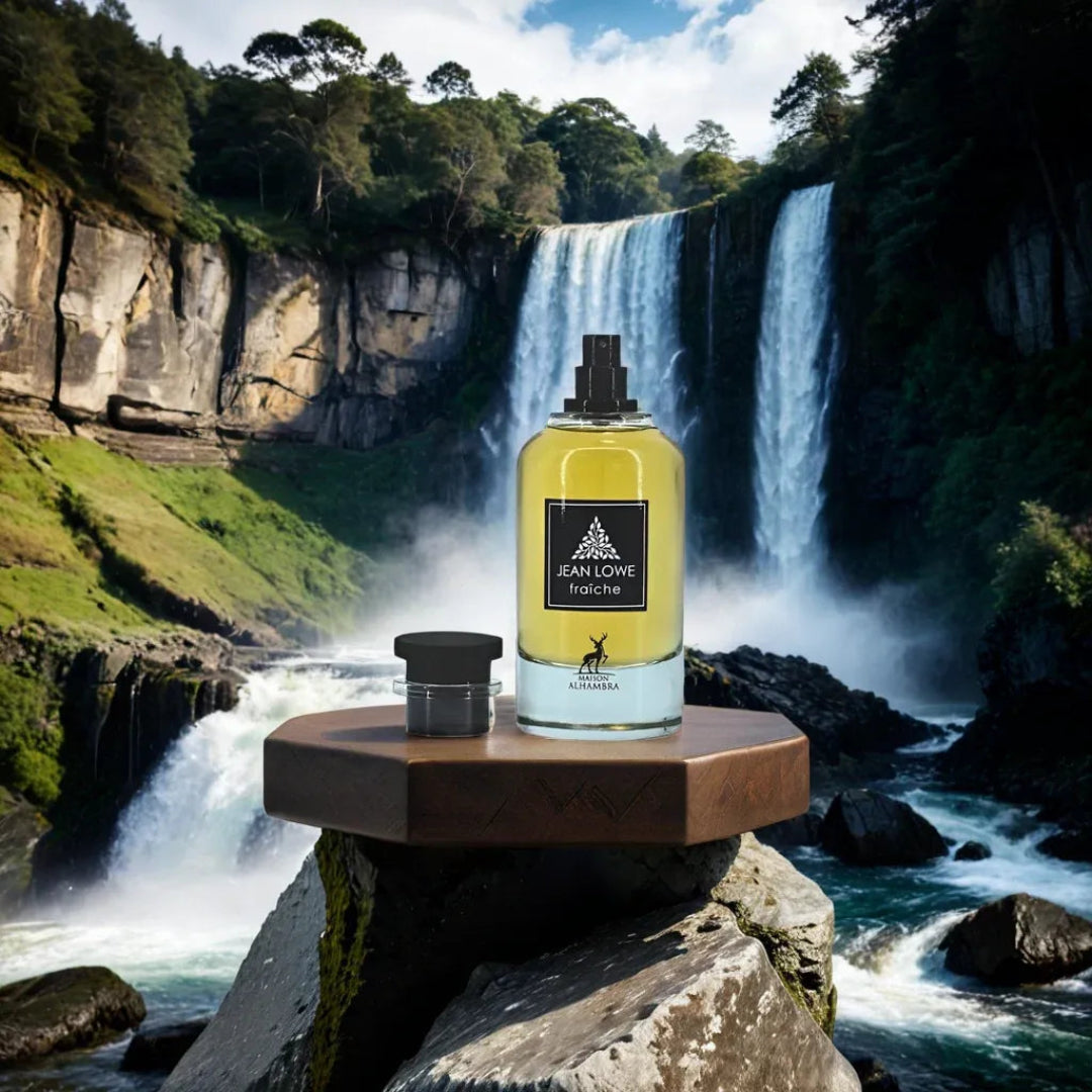 Perfume bottle on a wooden platform with a waterfall and forest in the background