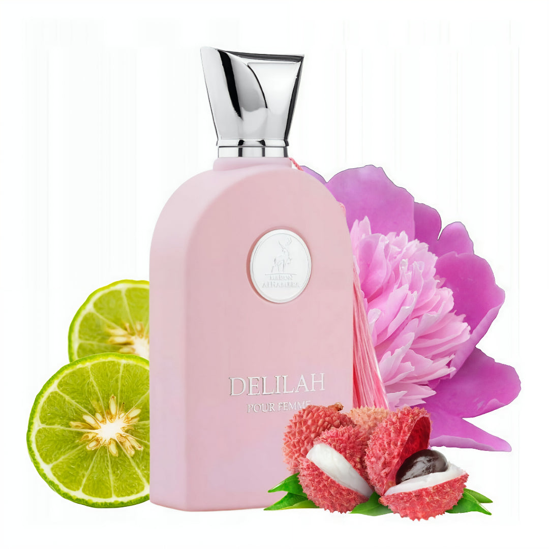 Pink perfume bottle with silver cap, surrounded by a lime, lychee fruit, and pink flower on a white background Delilah Maison Alhambra for women