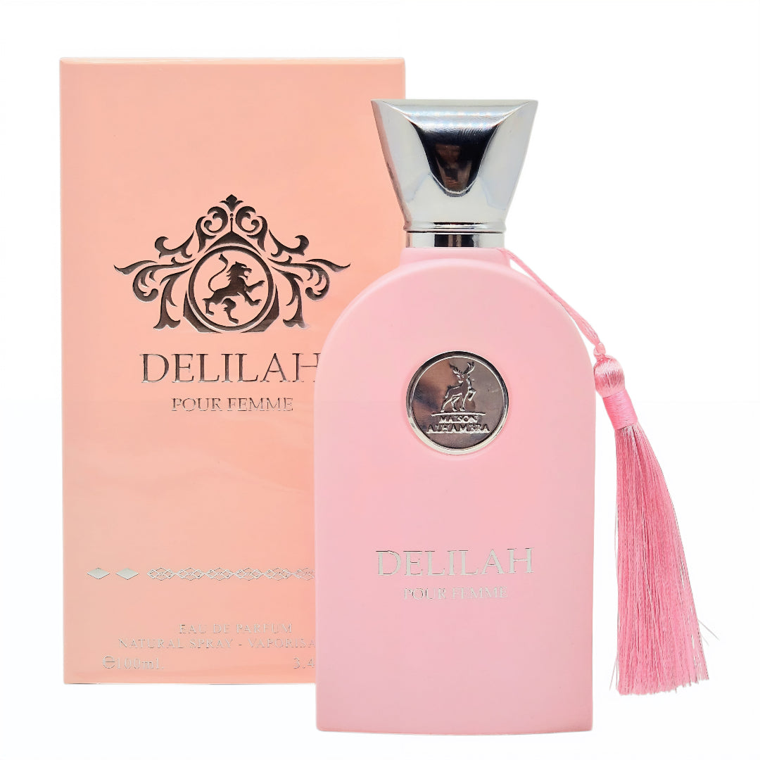 Pink Delilah perfume bottle with tassel and packaging on a white background