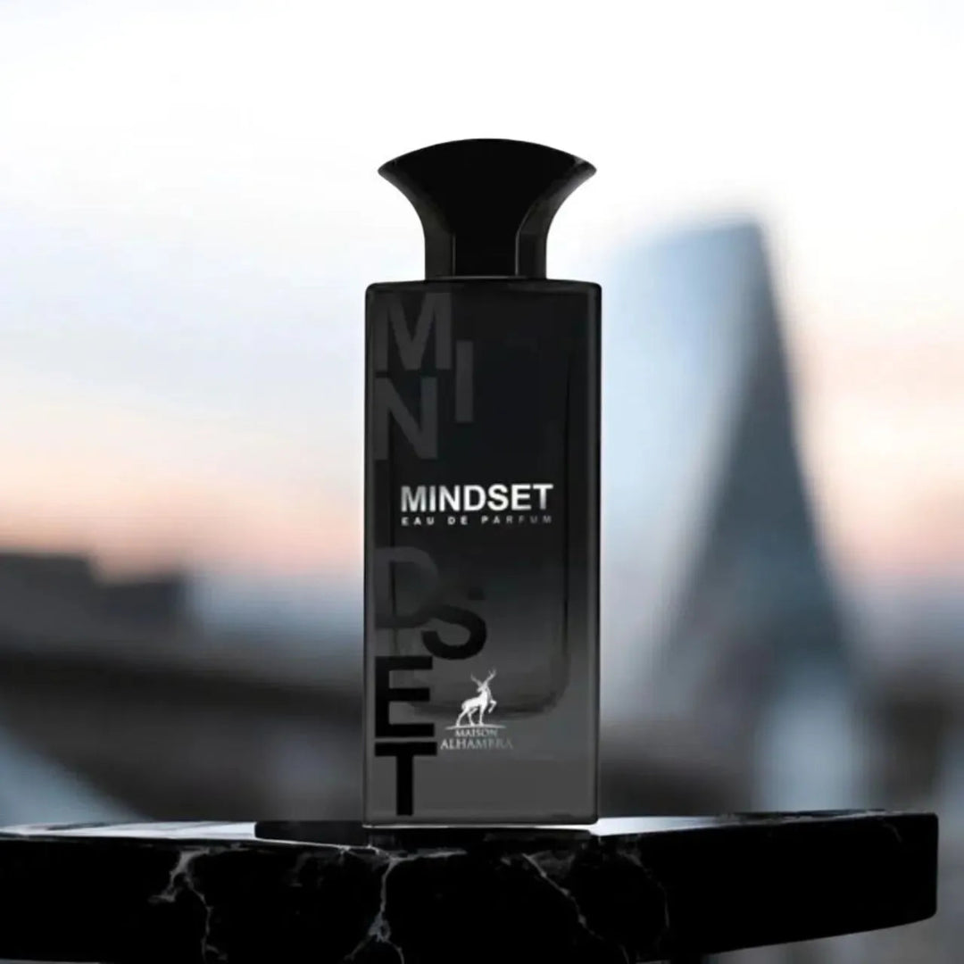 Black 'MINDSET' perfume bottle on a blurred cityscape background