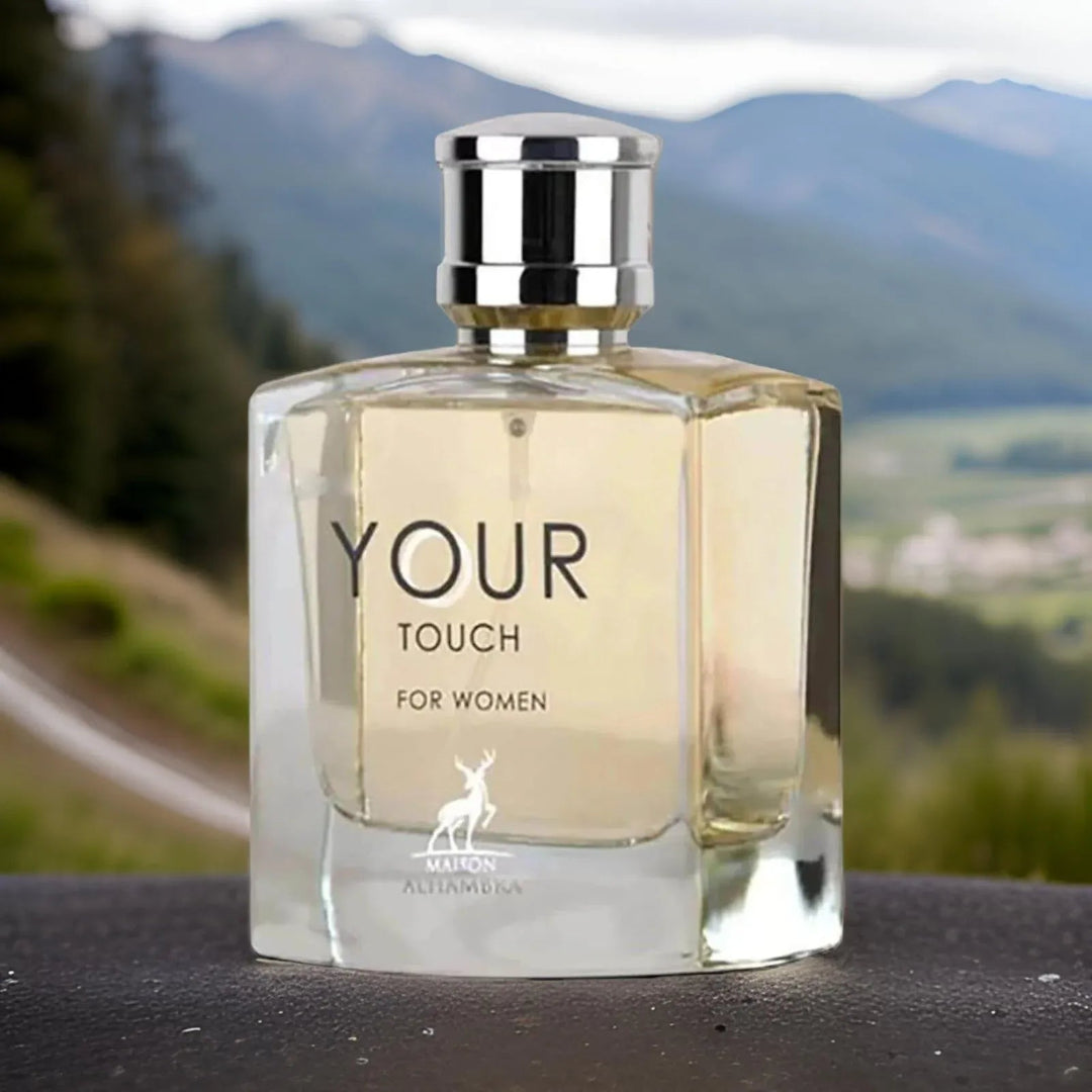 Perfume bottle labeled 'Your Touch for Women' with a scenic background
