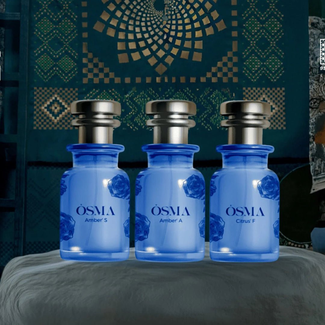 Three blue bottles labeled 'Osmia' on a gray surface with a decorative background.