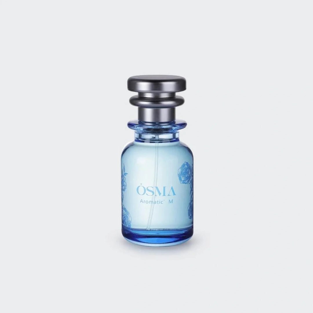 Blue perfume bottle with silver cap on a light gray background