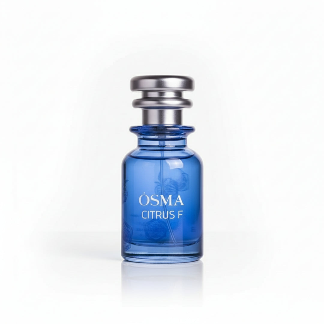 Blue perfume bottle with silver cap on a light gray background