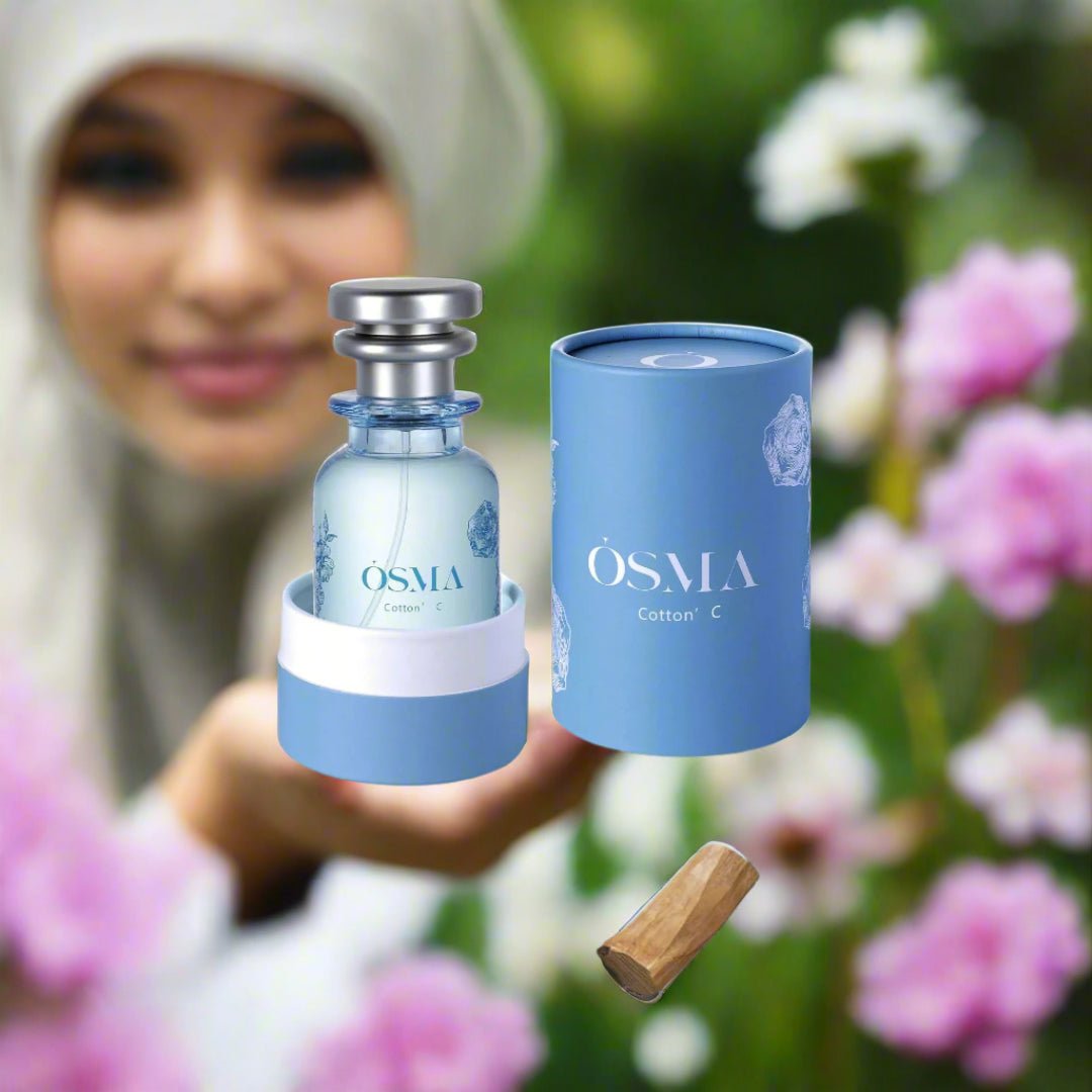OSMA perfume bottle and packaging on a light blue background with flowers.