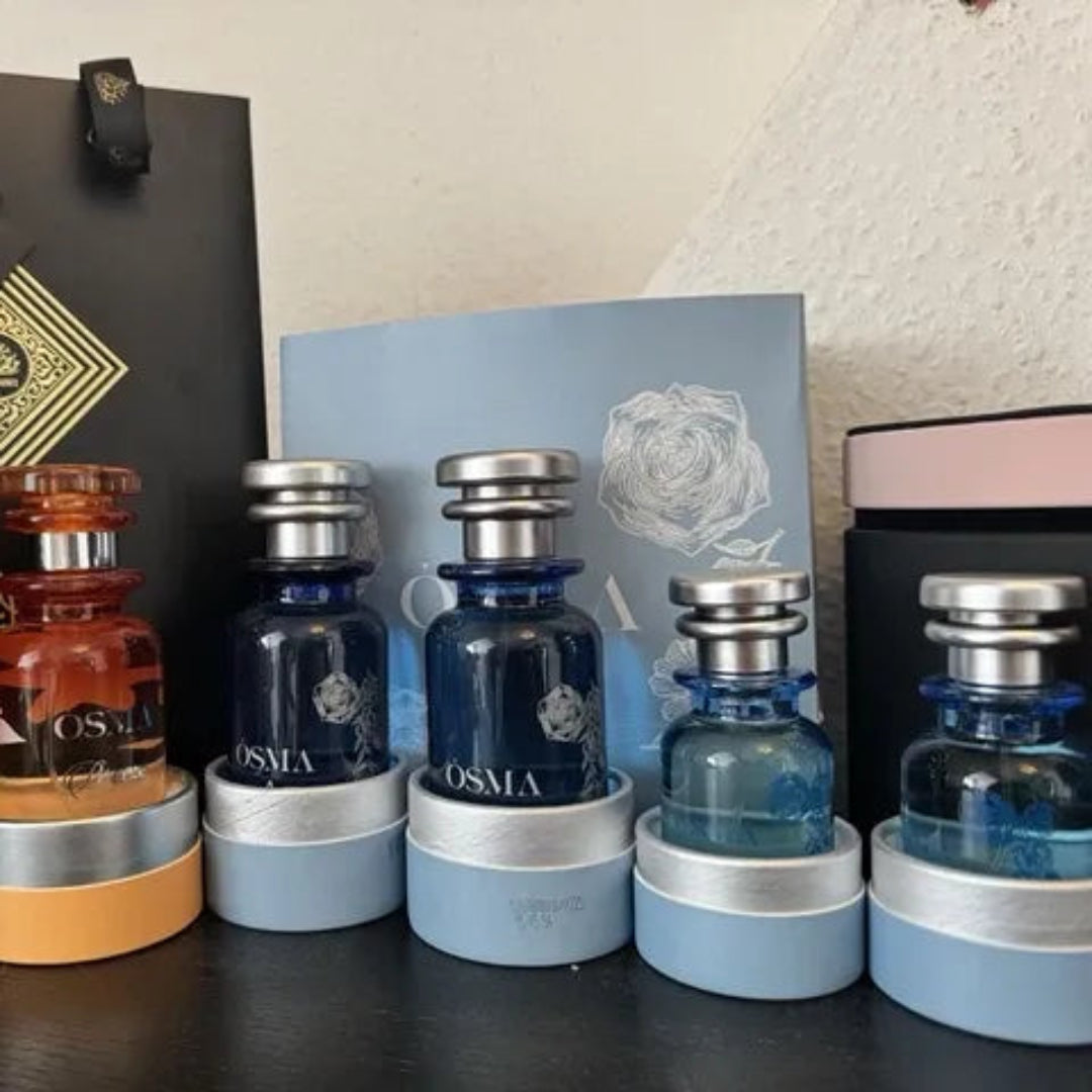 Collection of Osmia perfume bottles and packaging on a table.