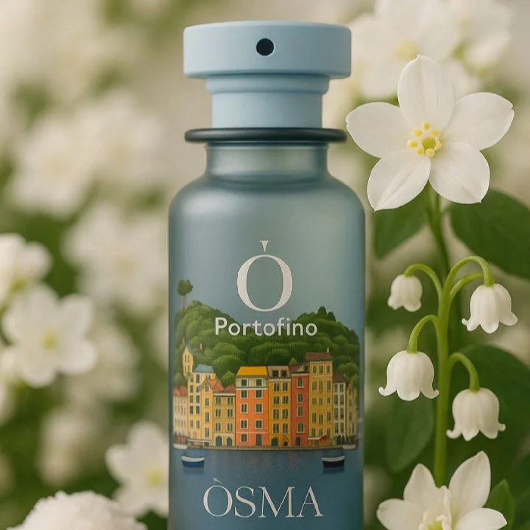 Blue bottle of Òsma Portofino perfume with flowers in the background