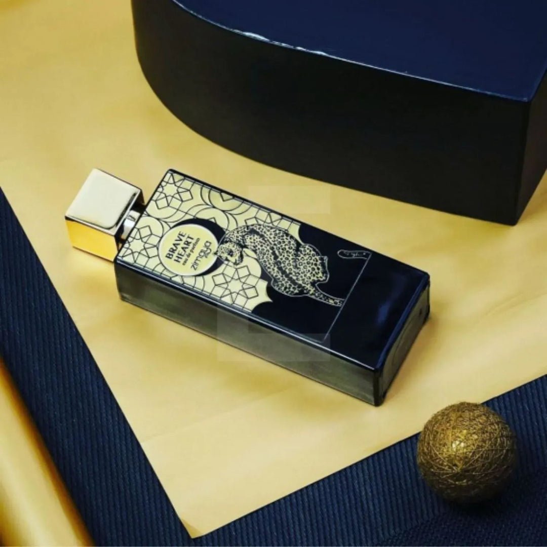 Perfume bottle with decorative packaging on a textured surface