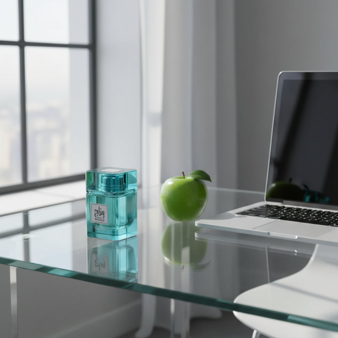 Mazaaj Rhythm by Zimaya perfume bottle on office desk with green apple and sunlight Malaysia
