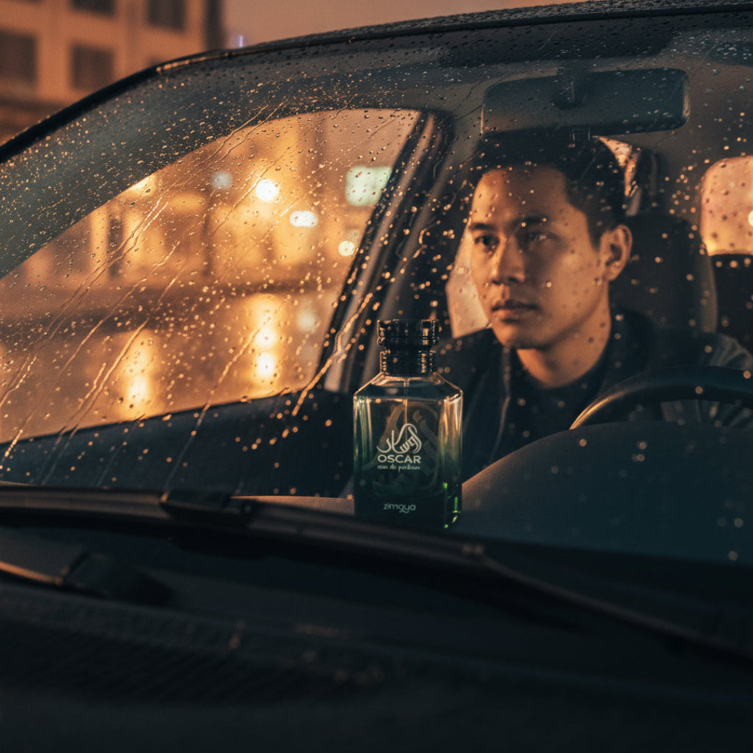 Malay man with Oscar by Zimaya perfume in car dashboard night rain amber reflection men perfume Malaysia