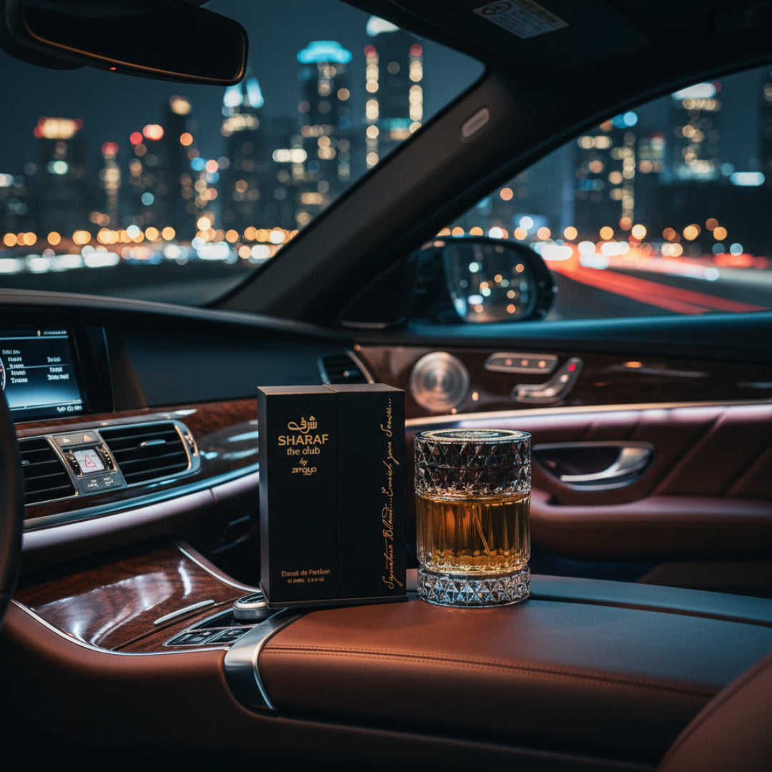 Bottle photographed inside luxury car with dashboard glow and city lights ahead