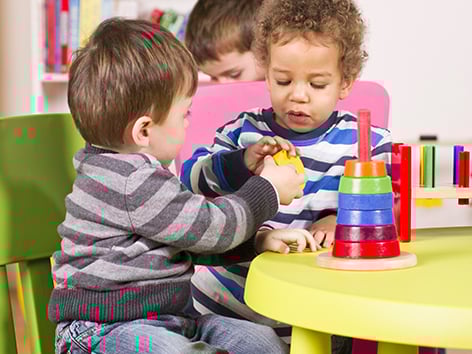 two young children playing with toys