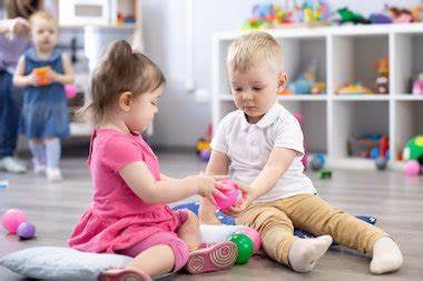 two young children playing with toys