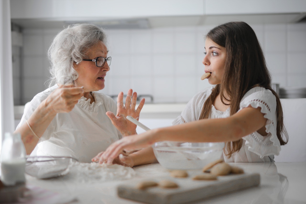 young girl and grandma baking cookies