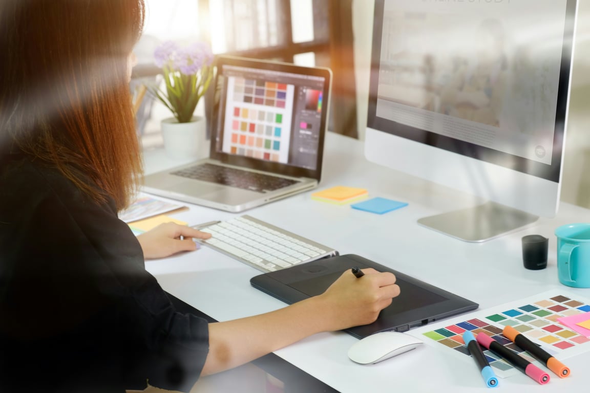 Graphic designer working on a floor plan at a digital tablet