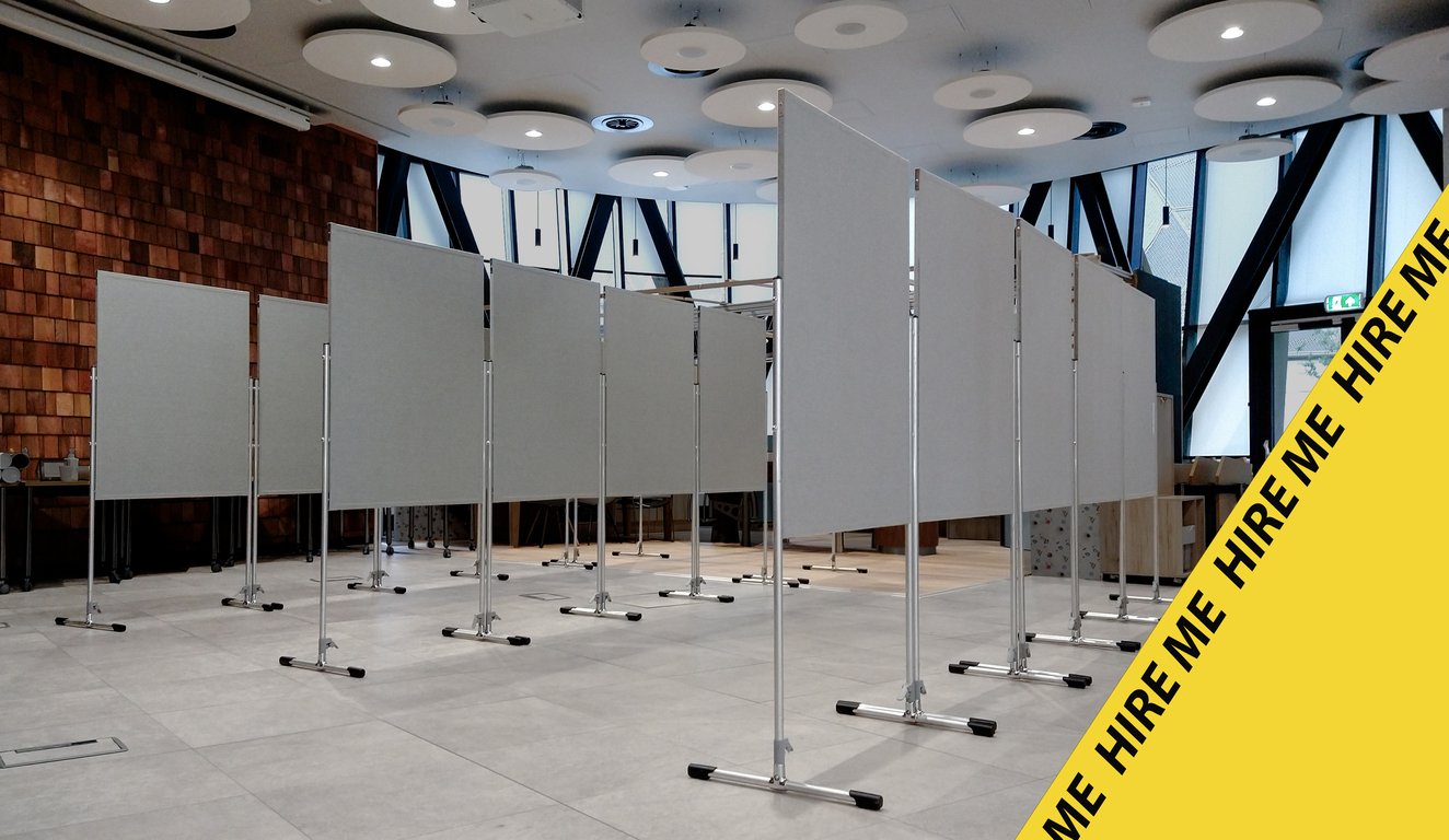 A hall set out with runs of double-sided display boards before an event