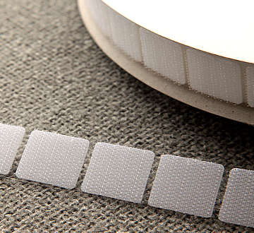 Close-up of Velcro coin mounted on the back of a poster