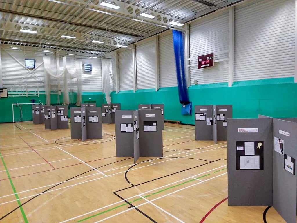 Poster boards set up in a sports hall