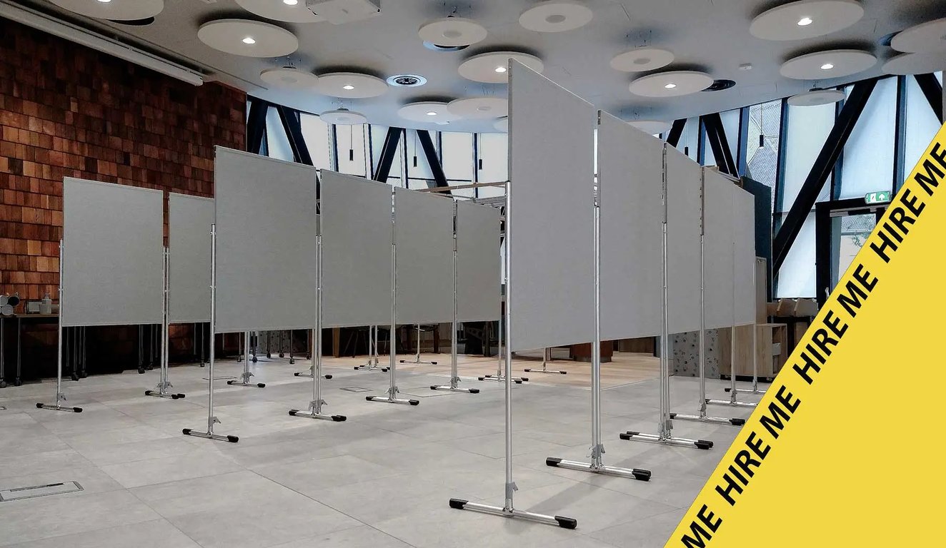 A hall set out with runs of double-sided display boards before an event