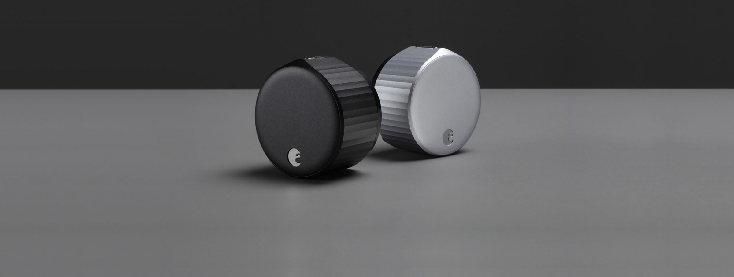 Two black white speaker buttons dark surface