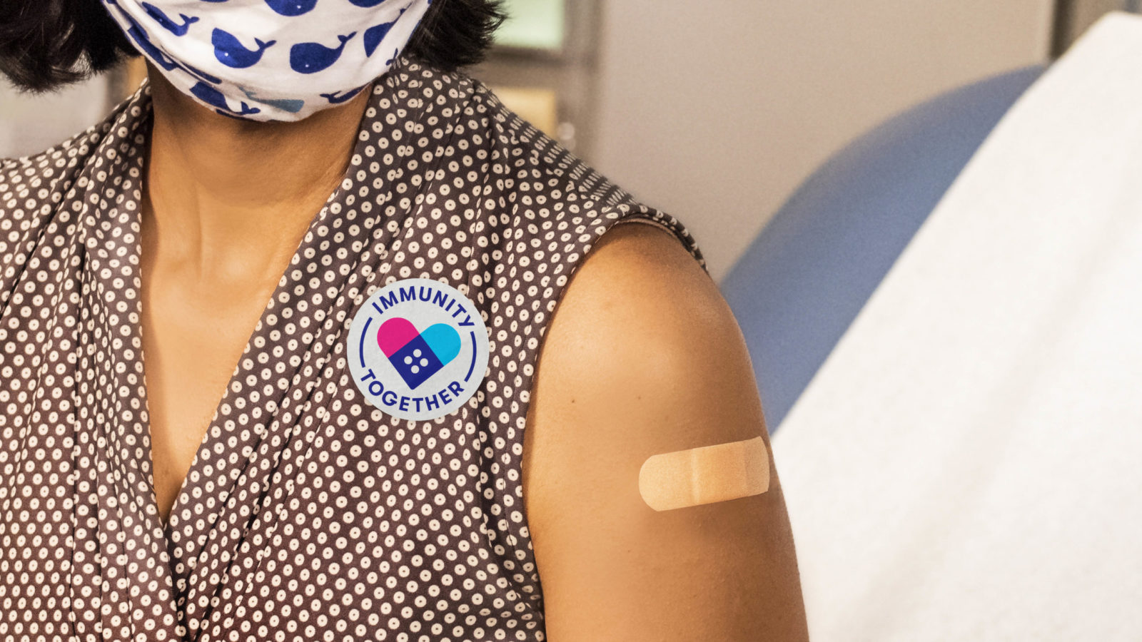Vaccinated person showing arm bandage sticker