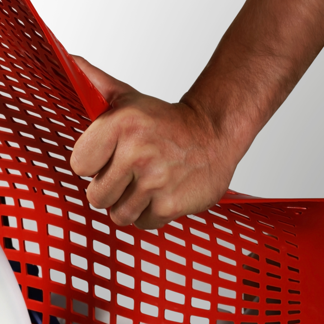 Hand holding red woven mesh material sample