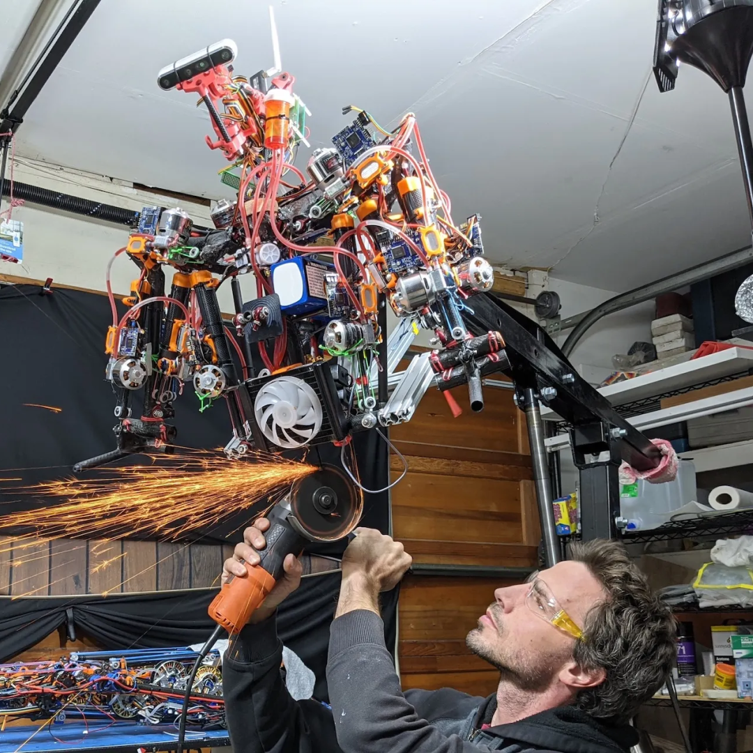 Middle-aged man with short hair and glasses working on a drone