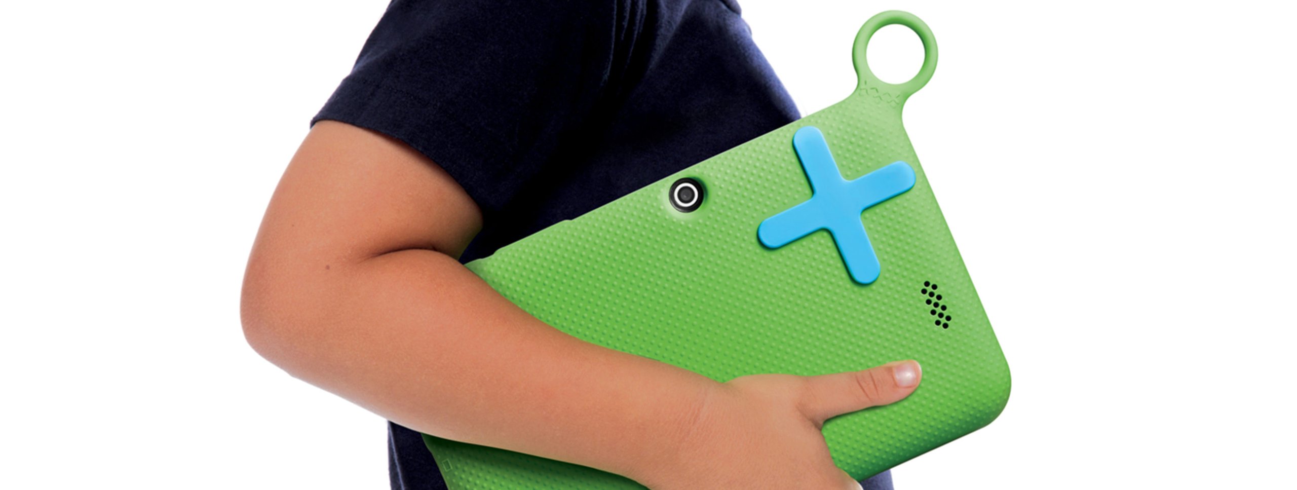 Child holding the OLPC XO green child-friendly tablet under one arm, showing the textured rubber back, blue plus button, came