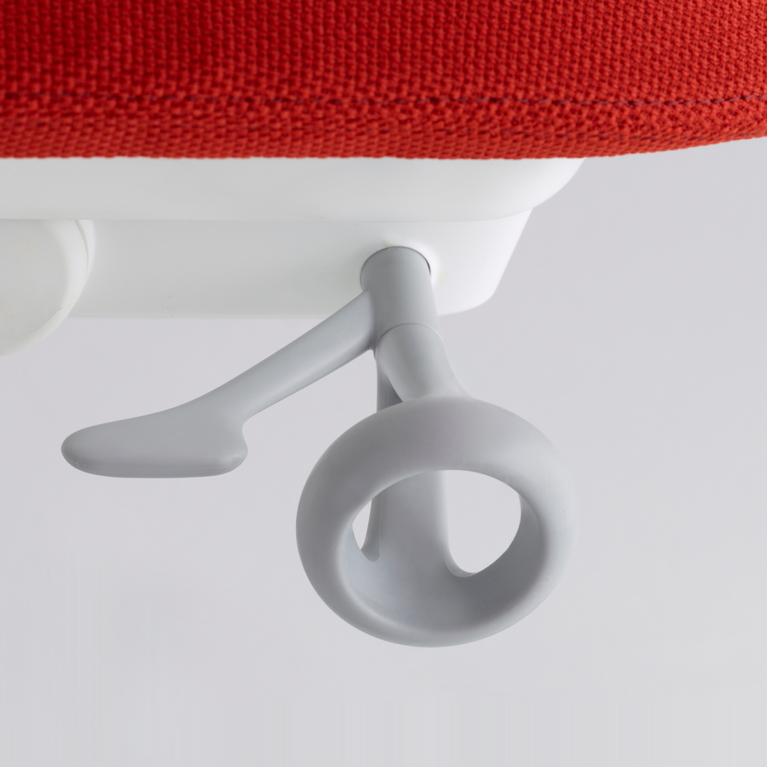 Red chair with white armrest against a white background
