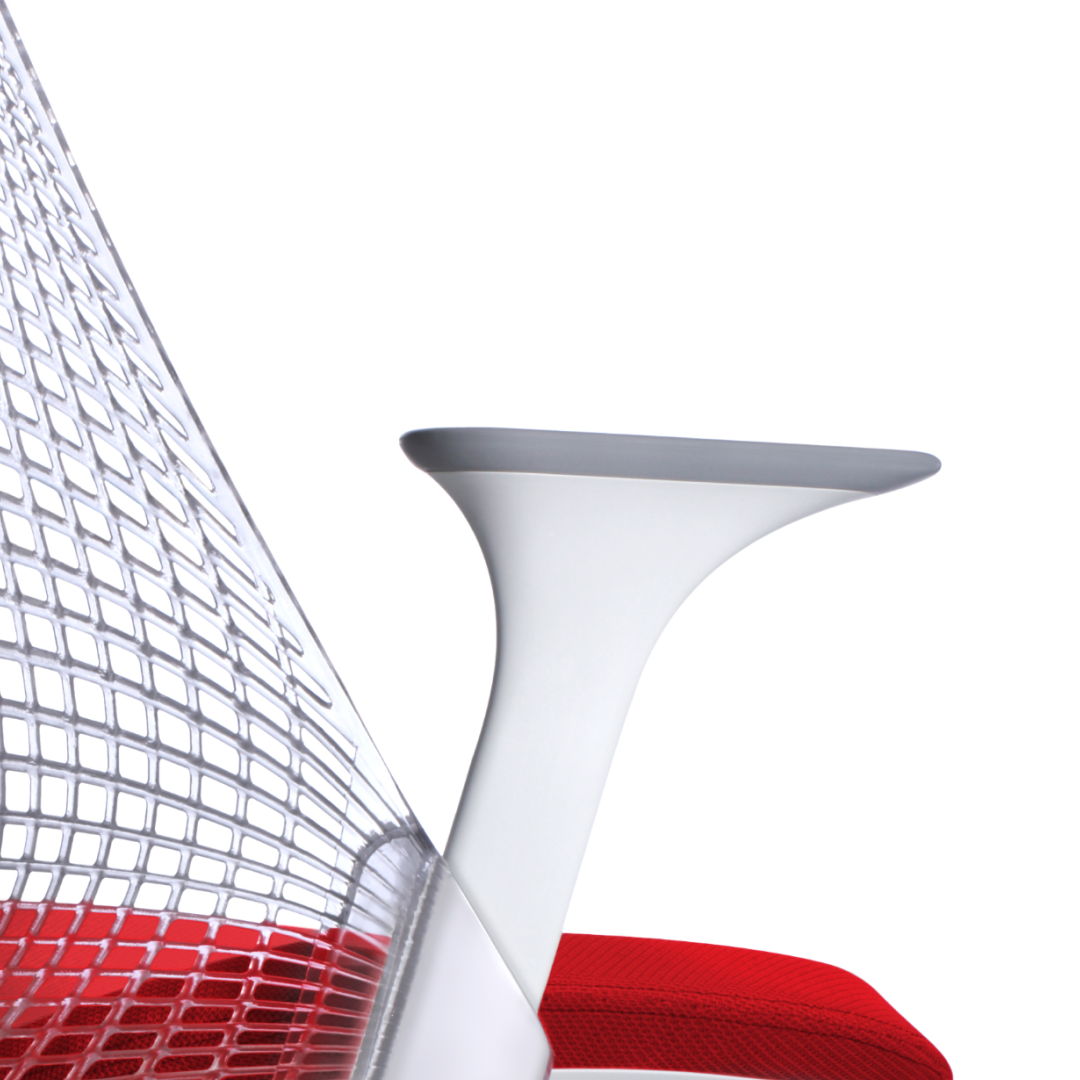 Red upholstered chair with curved back and armrests on a white background