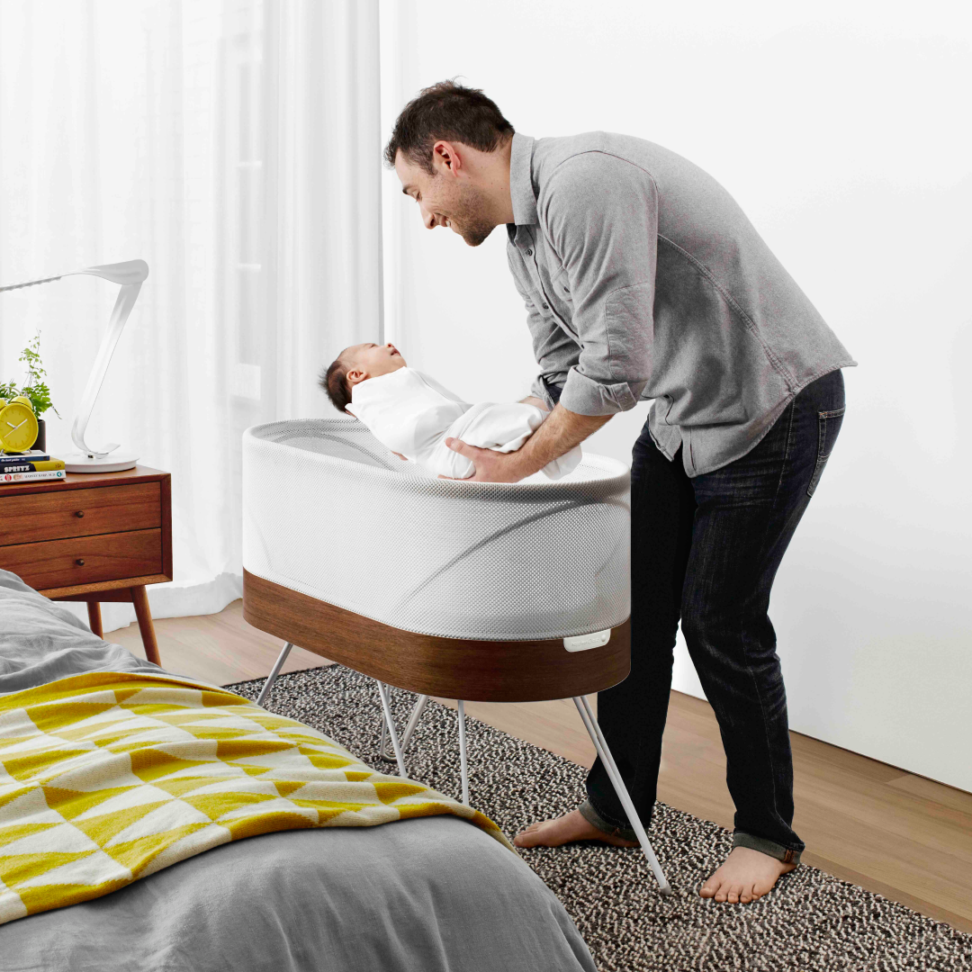 Father with baby in SNOO smart bassinet