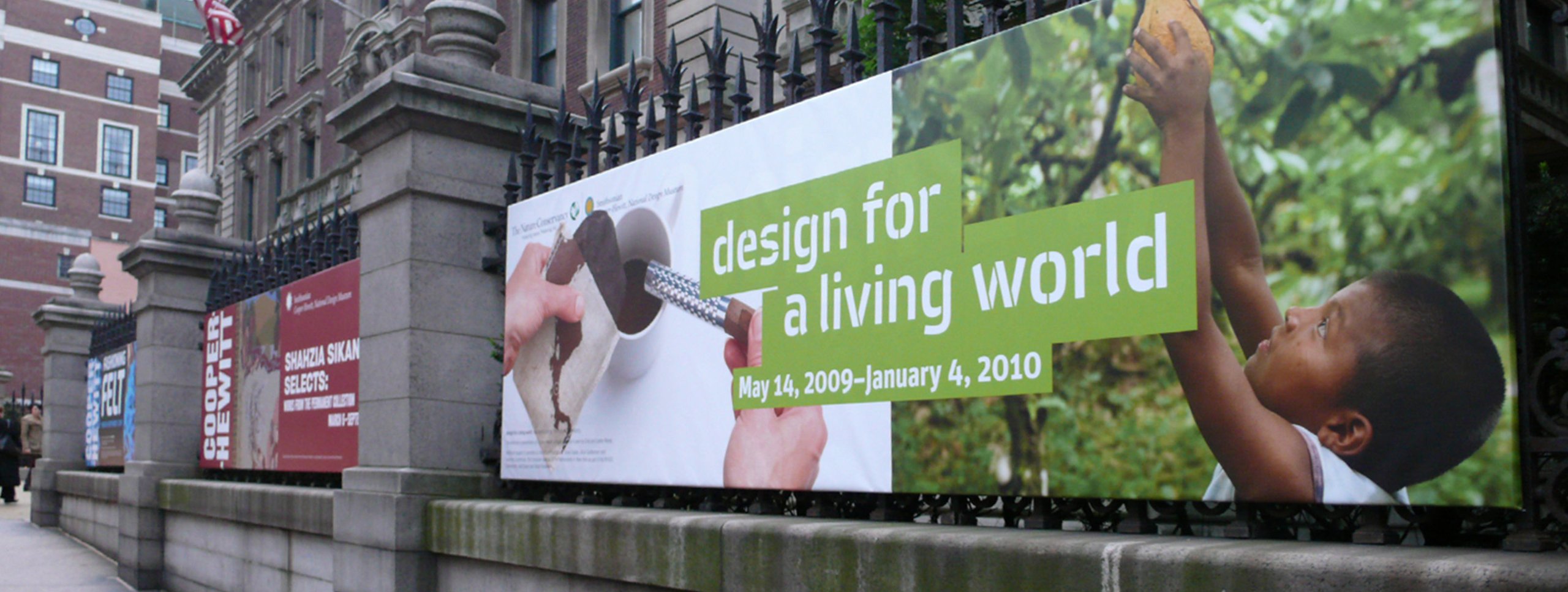Cooper Hewitt museum exterior banner for Design for a Living World exhibition, May 14 2009 to January 4 2010, on iron fence
