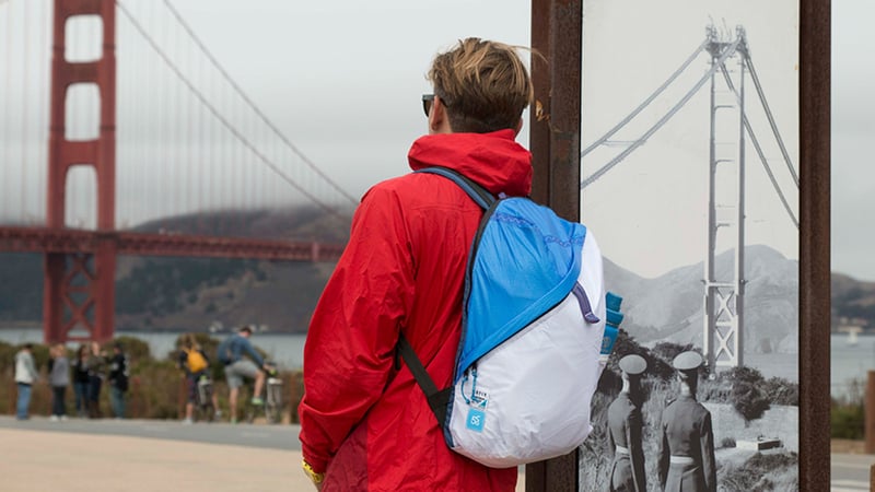 Traveler with red jacket near Golden Gate