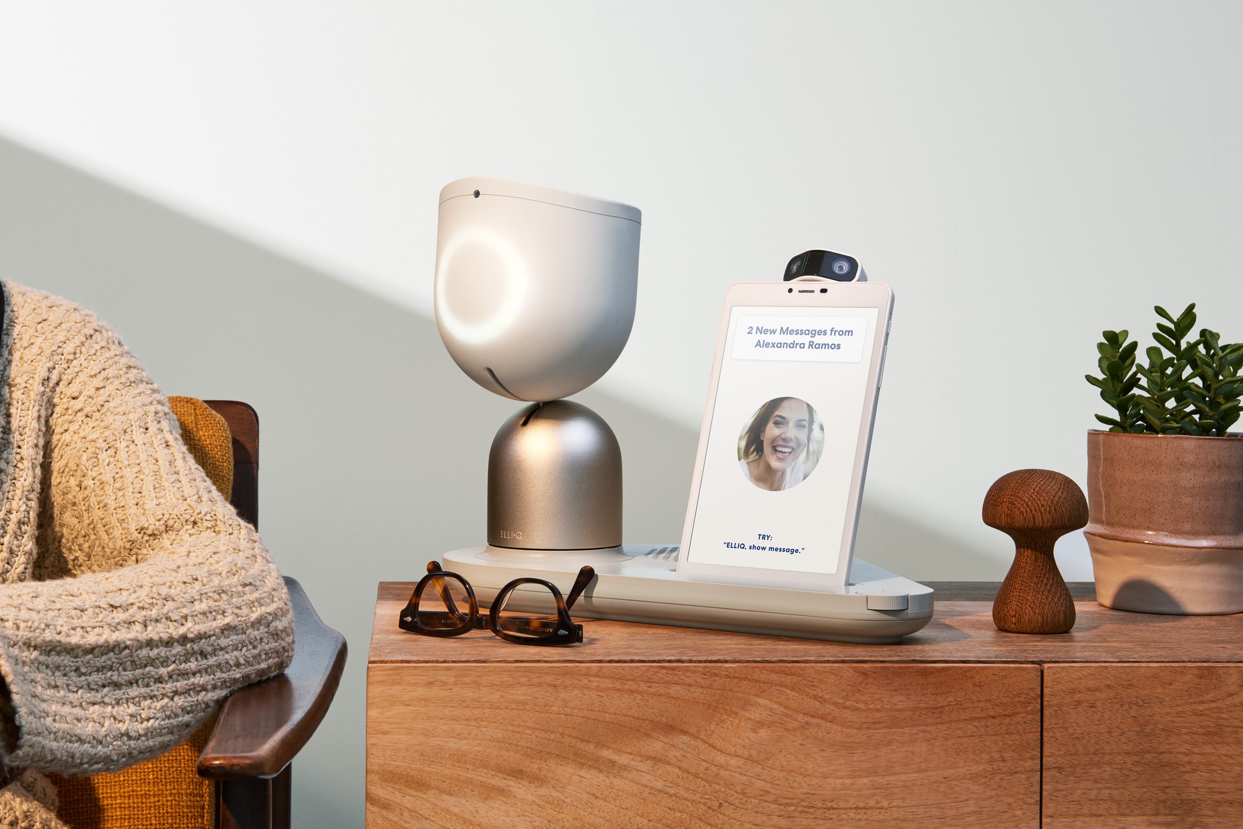 Smart speaker with camera lens on top and a sign with black