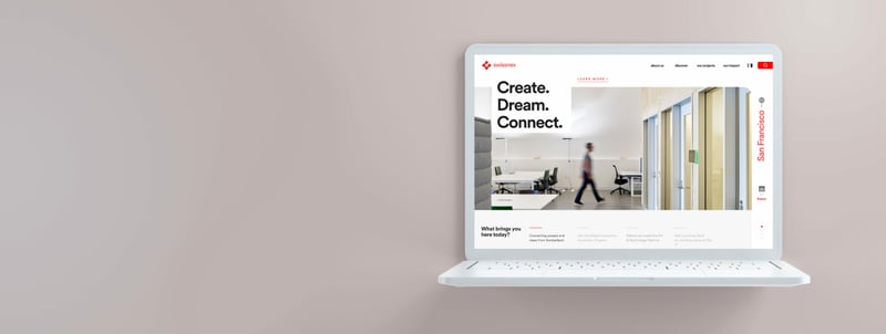 Laptop displaying modern office workspace design