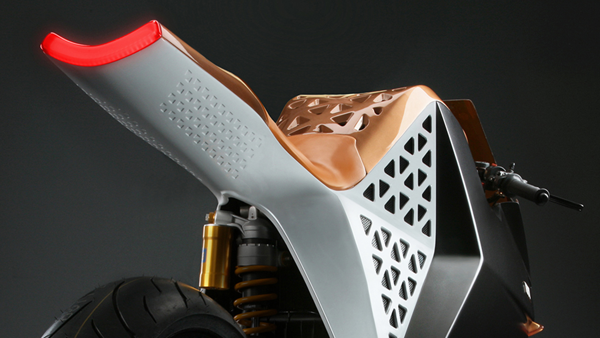 Futuristic motorcycle with white and gold design against dark background